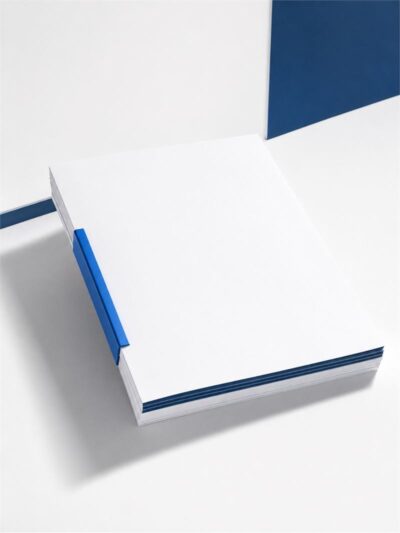 A closed press kit folder in white with a navy spine.